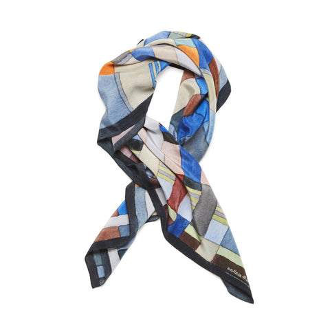 Silk scarf with a striped brush stroke pattern, rolled and styled.