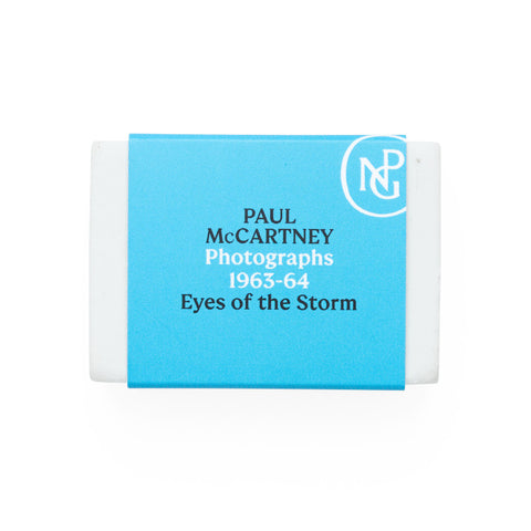 White eraser with blue band featuring the NPG logo and 'Paul McCartney Eyes of the Storm' exhibition title. 