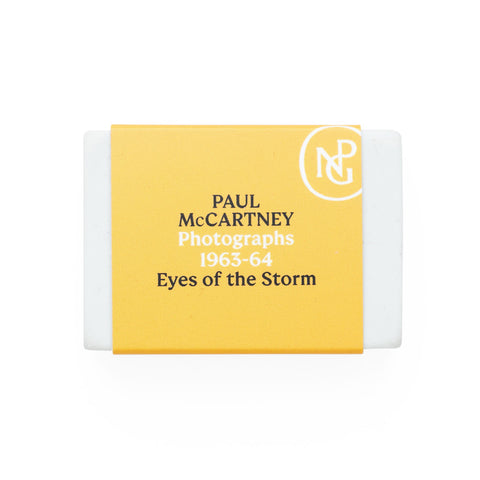 White eraser with yellow band featuring the NPG logo and 'Paul McCartney Eyes of the Storm' exhibition title. 