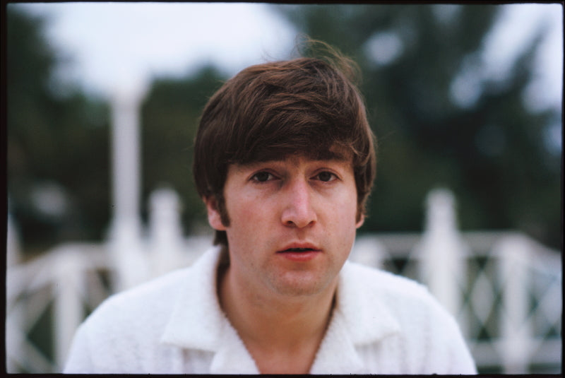 Limited edition photographic print of john lennon in a white shirt with trees in the background, taken by paul mccartney.