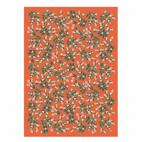 Orange wrapping paper with small sprigs of mistletoe. 