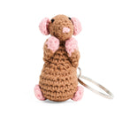 Crocheted rat keychain with pink ears and feet on a white background
