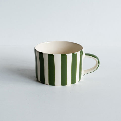 Wide mug with handle featuring green vertical painted stripes.