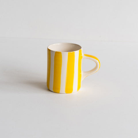Ceramic painted mug with wide painted stripes in yellow.