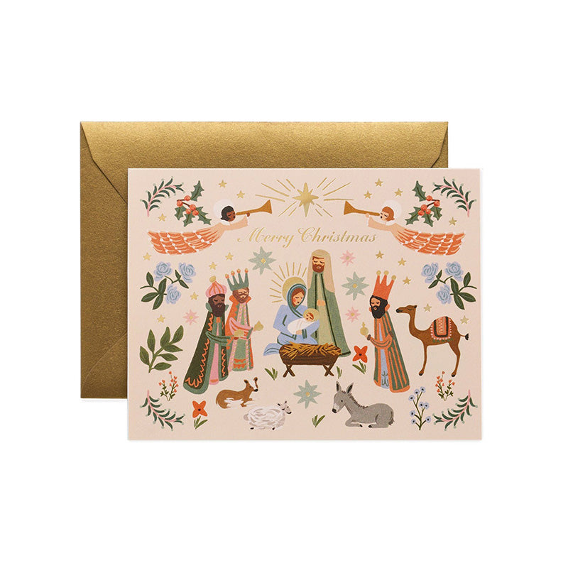 A nativity scene christmas card and a gold envelope. 