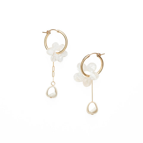 Small gold hoops with an ivory flower charm and a dangling pearl below.
