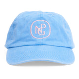 A bright blue baseball hat with a baby pink NPG logo, front view. 