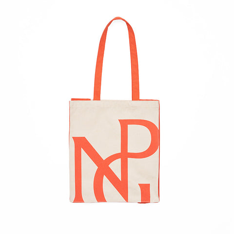 Front view of a large rectangular cream tote bag with red handles and sides and NPG monogram logo in red.