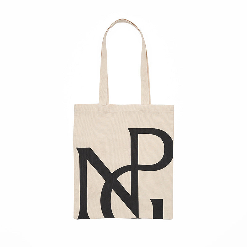 A cream tote bag with large npg monogram design in black.