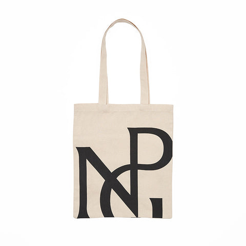 A cream tote bag with large NPG monogram design in black.