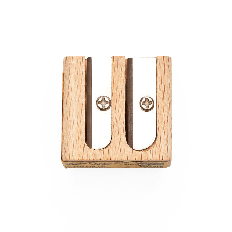 Reverse of wooden sharpener with two metal blades for sharpening pencils.