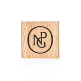 A square wooden sharpener with the NPG monogram in black on top. 