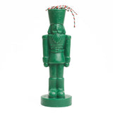 Green nutcracker shaped candle. 