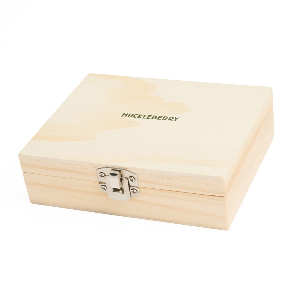 A wooden box with metal closure and the word 'huckleberry' on the top.