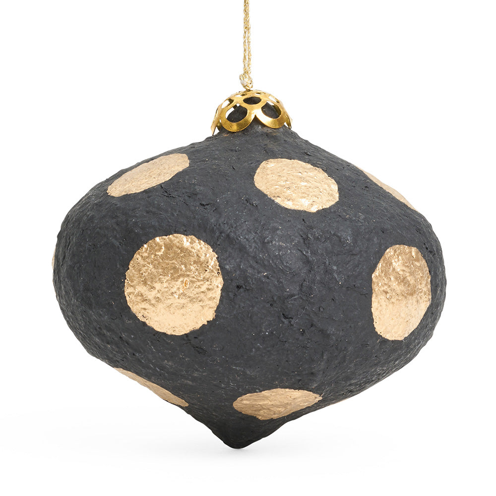 An onion shaped paper mache decoration in black with gold polka dots. 