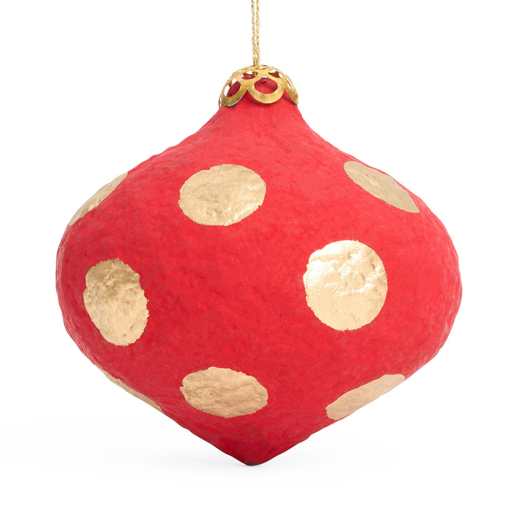 An onion shaped paper mache decoration in red with gold polka dots. 