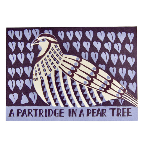 Blue and purple card with a white partridge on it with the wording "Partridge in a pear tree" on it. 