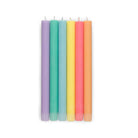 Image: 6 pastel rainbow coloured tall candles placed in a row.