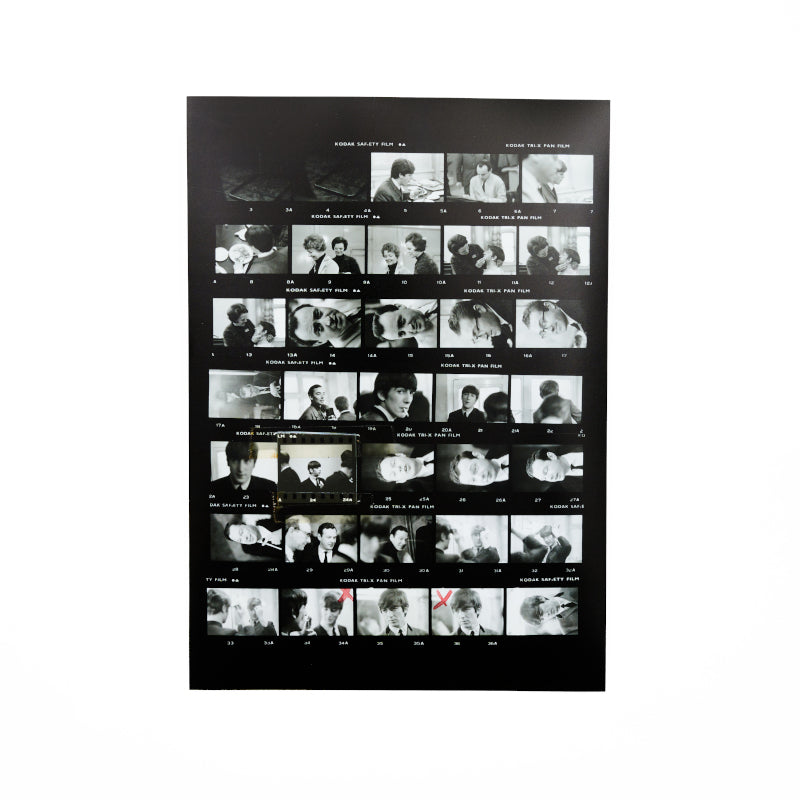 Black and white contact sheet featuring photographs of the beatles with red pen marks.