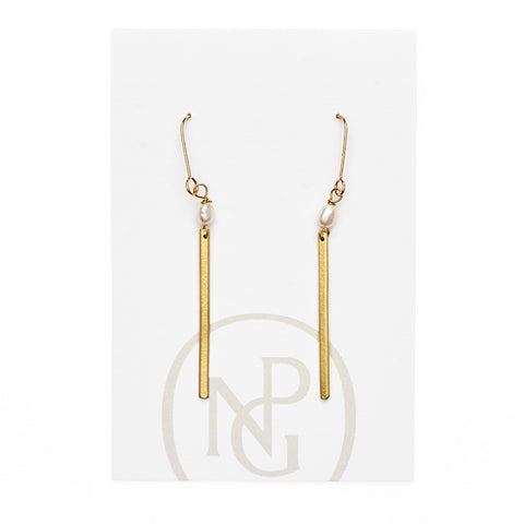 A pair of gold hoop earrings with a single pearl and gold bar hanging from each below on NPG packaging. 
