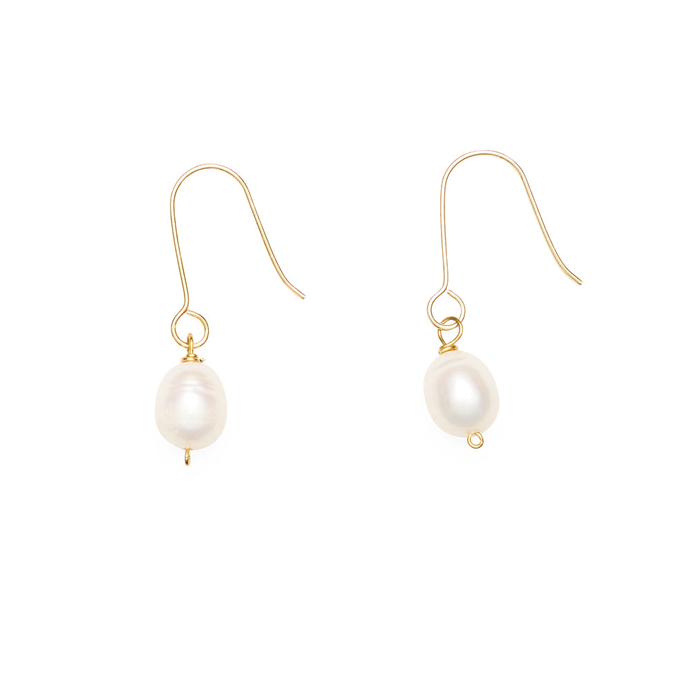 Pair of pearl earrings with gold hooks on a white background