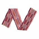 Colourful striped scarf with textured panels on a white background