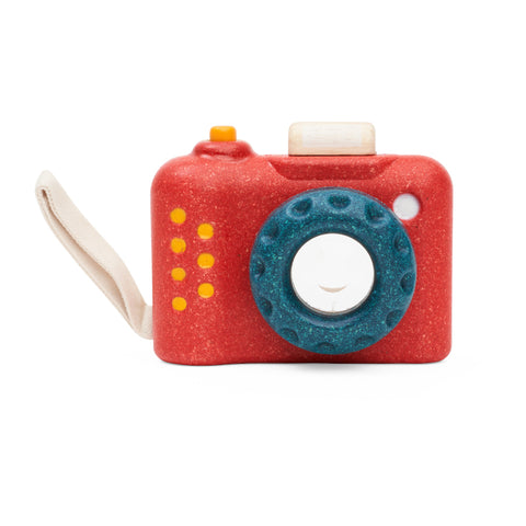Red wooden camera toy with kaleidoscope lens. 