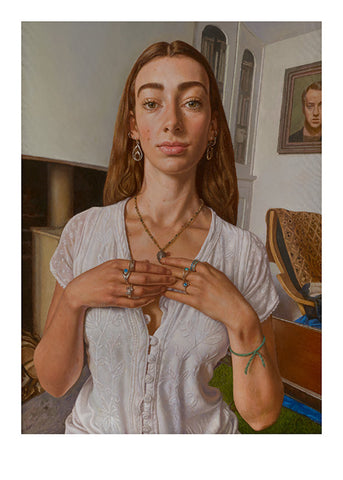 A portrait of a woman in white blouse with rings on her hands holding her necklace on her chest.