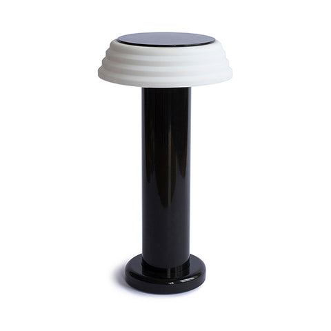 Compact lamp with a long black base and white top.