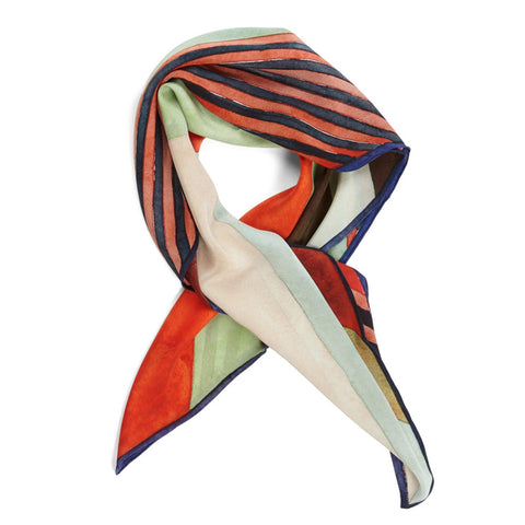 Printed silk scarf in striped brush stroke pattern folded and styled.