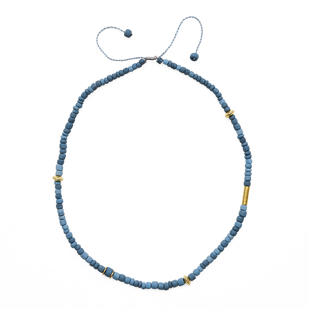 Blue beaded necklace with gold accents on a white background