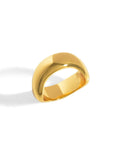 side view of the chunky gold ring with a wave in the band design. 