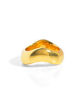 A chunky gold ring with the band waving rather than staying in a perfect circle. 