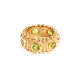 Front view of a textured gold ring with large emerald green crystals and smaller silver crystals embedded in the band.