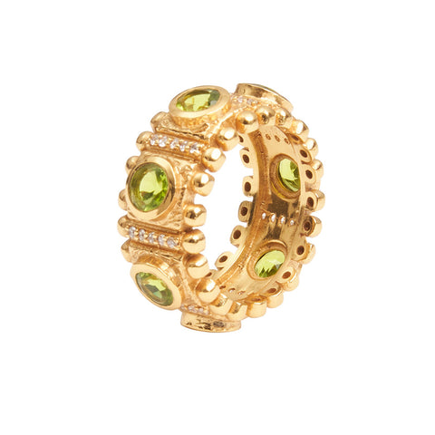 Side view of a textured gold ring with large emerald green crystals and smaller silver crystals embedded in the band.