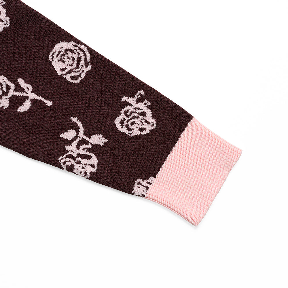 Cardigan sleeve with floral pattern and pink cuff on a white background