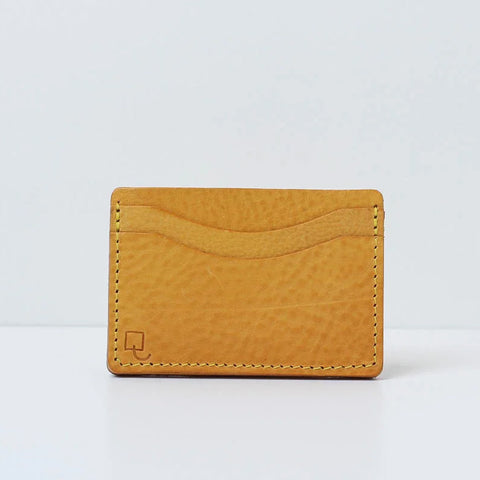 Rectangular yellow leather card holder with two card compartments. 