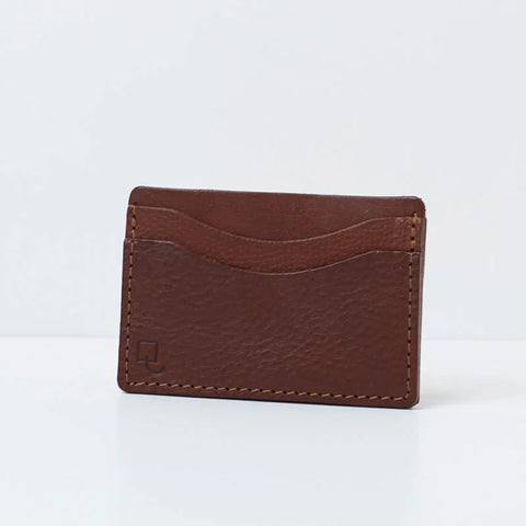 Rectangular tan brown leather card holder with two card compartments. 
