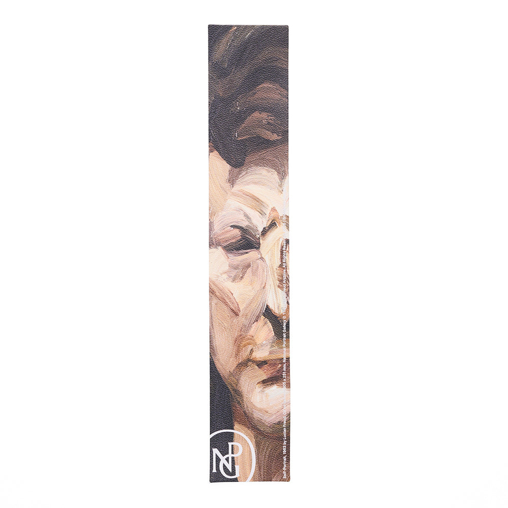 Leather bookmark with abstract painted face design on a white background