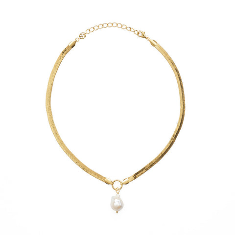 A snake chain gold necklace with a large hanging pearl pendant.