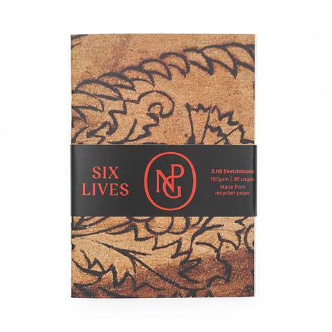 Three notebooks wrapped with a central paper band printed with the Six Lives exhibition title and NPG monogram in red. 