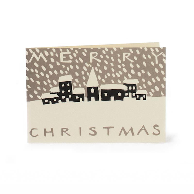 An image of a small christmas card showing a print of a small town covered in snow with the message 'merry christmas'