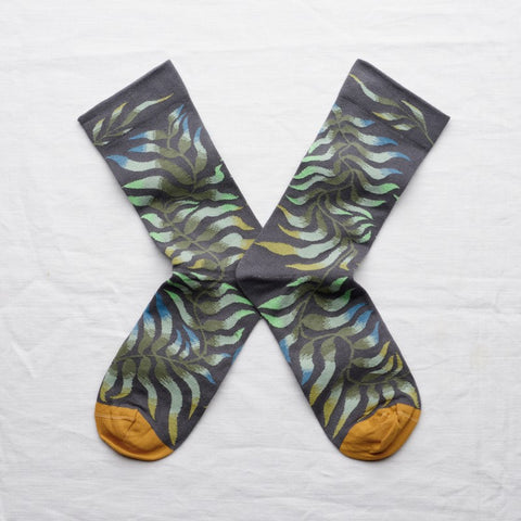 A pair of steel coloured socks featuring a leaf pattern.