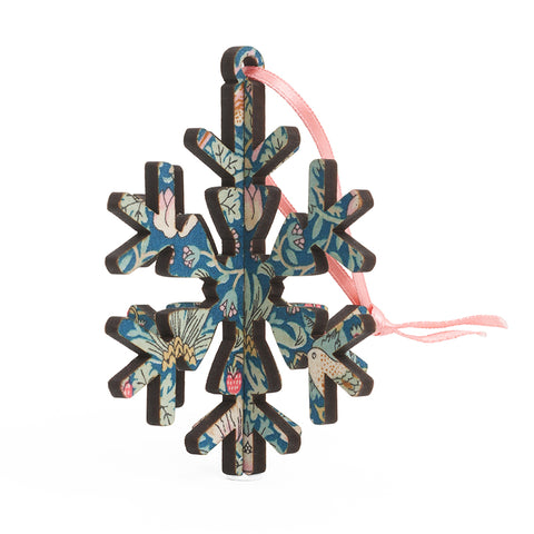 A blue and pink fabric decorated 3D snowflake decoration. 