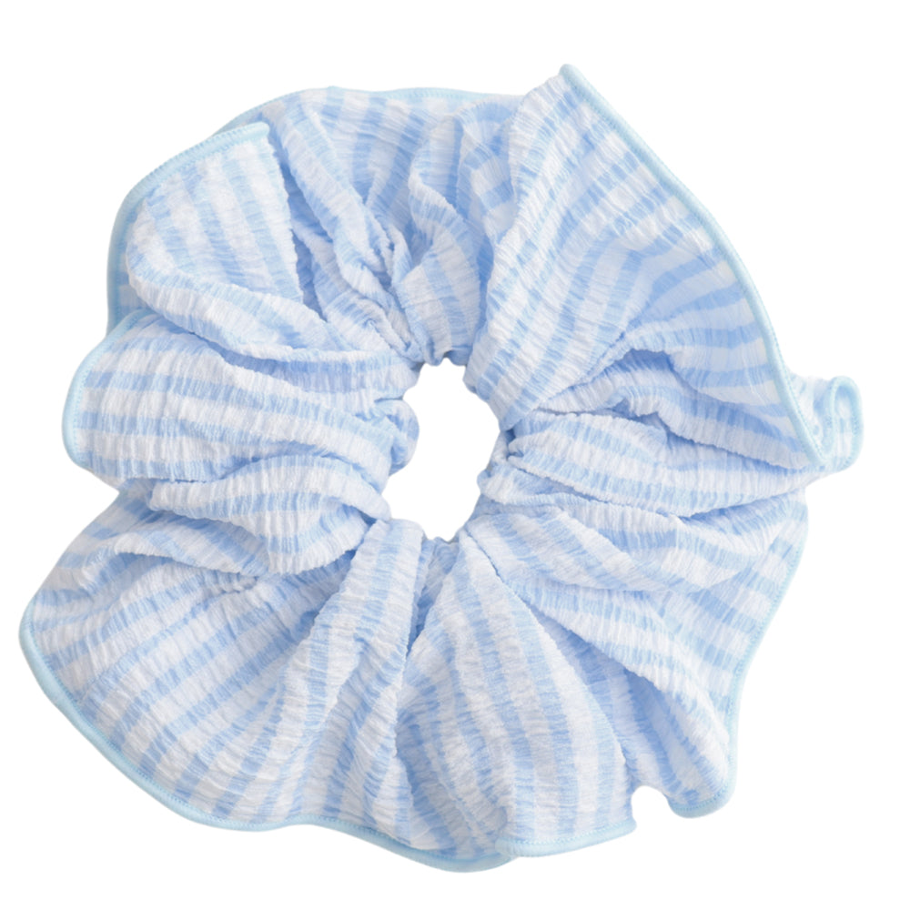 White and blue striped hair scrunchie against a white background.