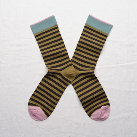 Absinth green and black stripped socks with pink toes and pink and blue trim.
