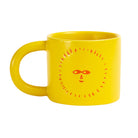 Yellow ceramic mug with a sun design on a white background