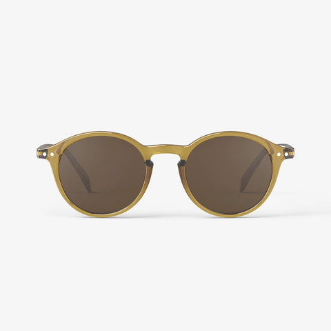 A pair of sunglasses in a light golden green frame.