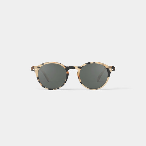 A pair of round sunglasses in a light tortoiseshell frame.