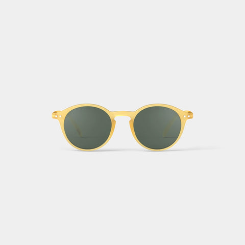 A pair of round sunglasses in a yellow honey frame.